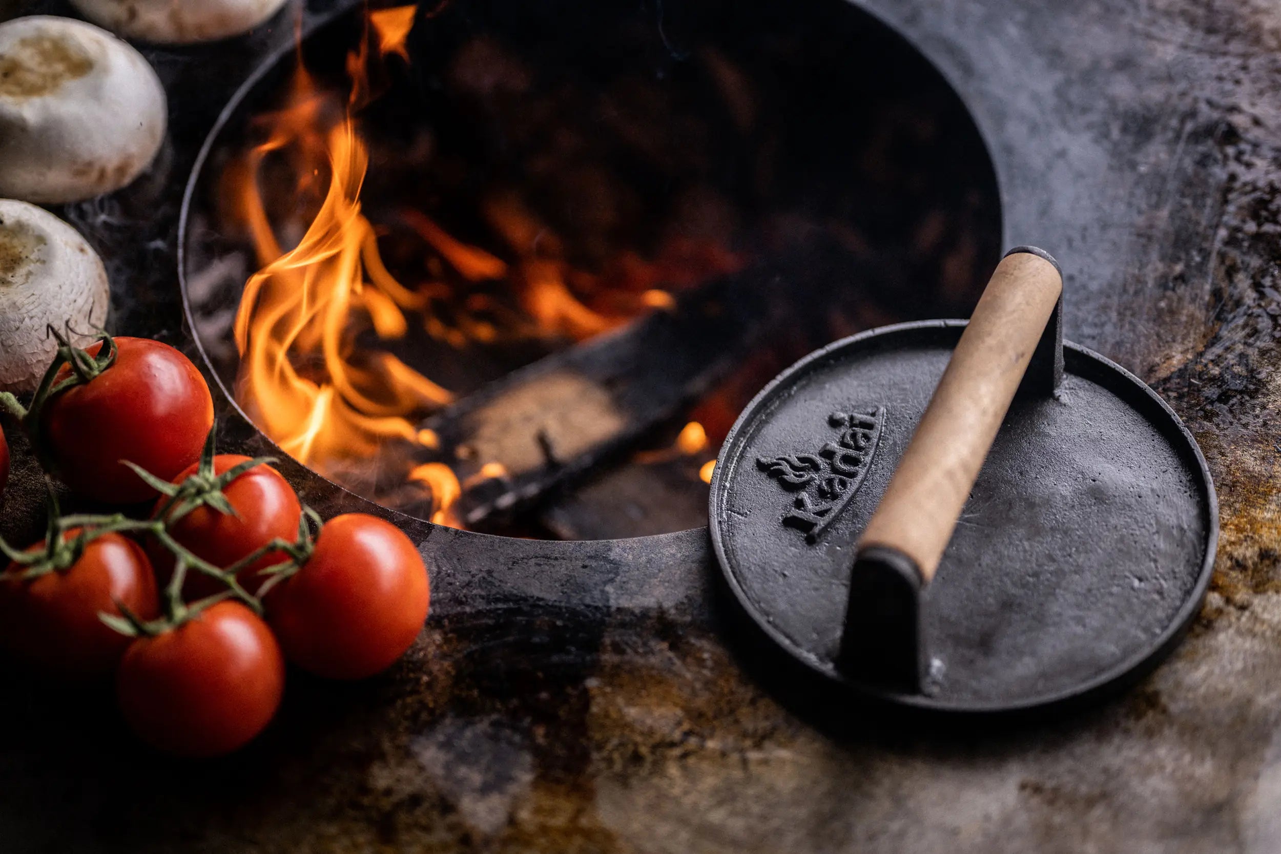 lifestyle shot of burger press and food cooking on plancha kadai