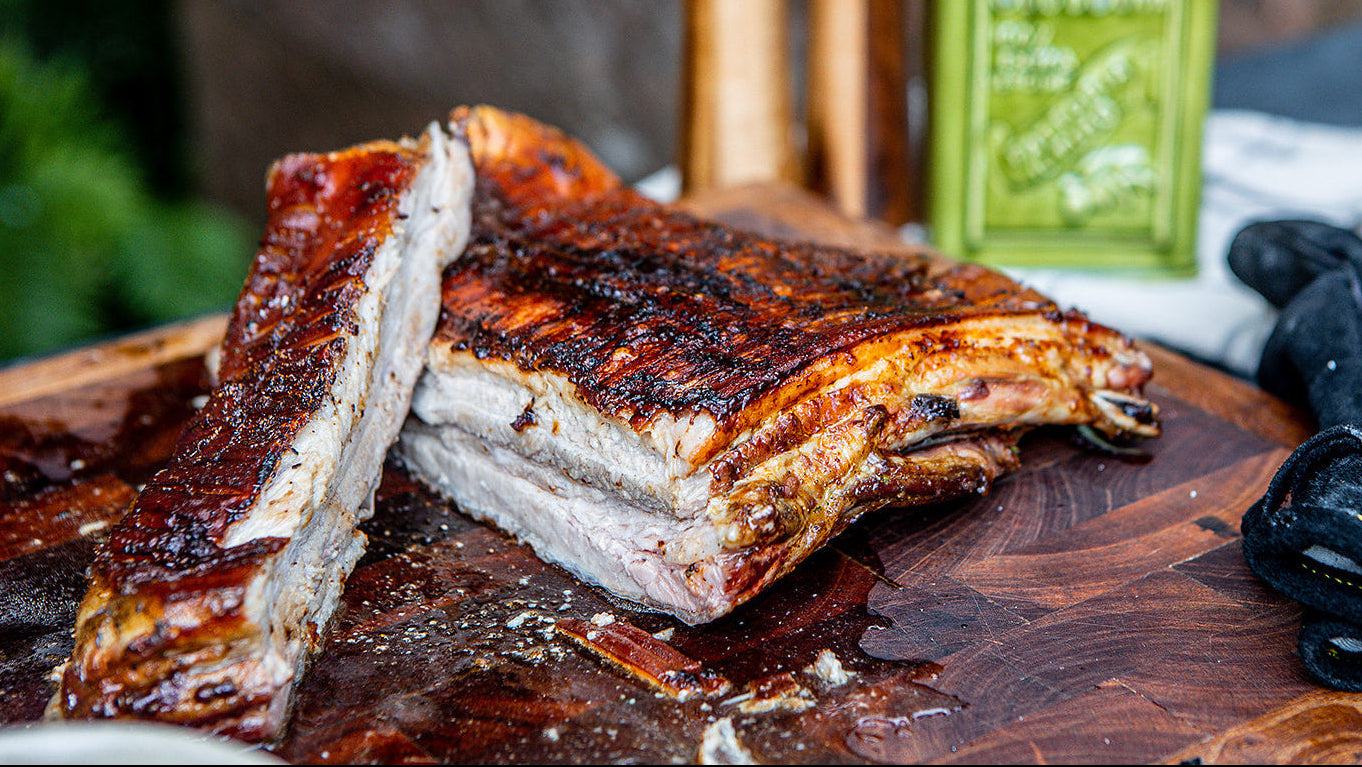 Pork belly on a wooden cutting board with a blurred background