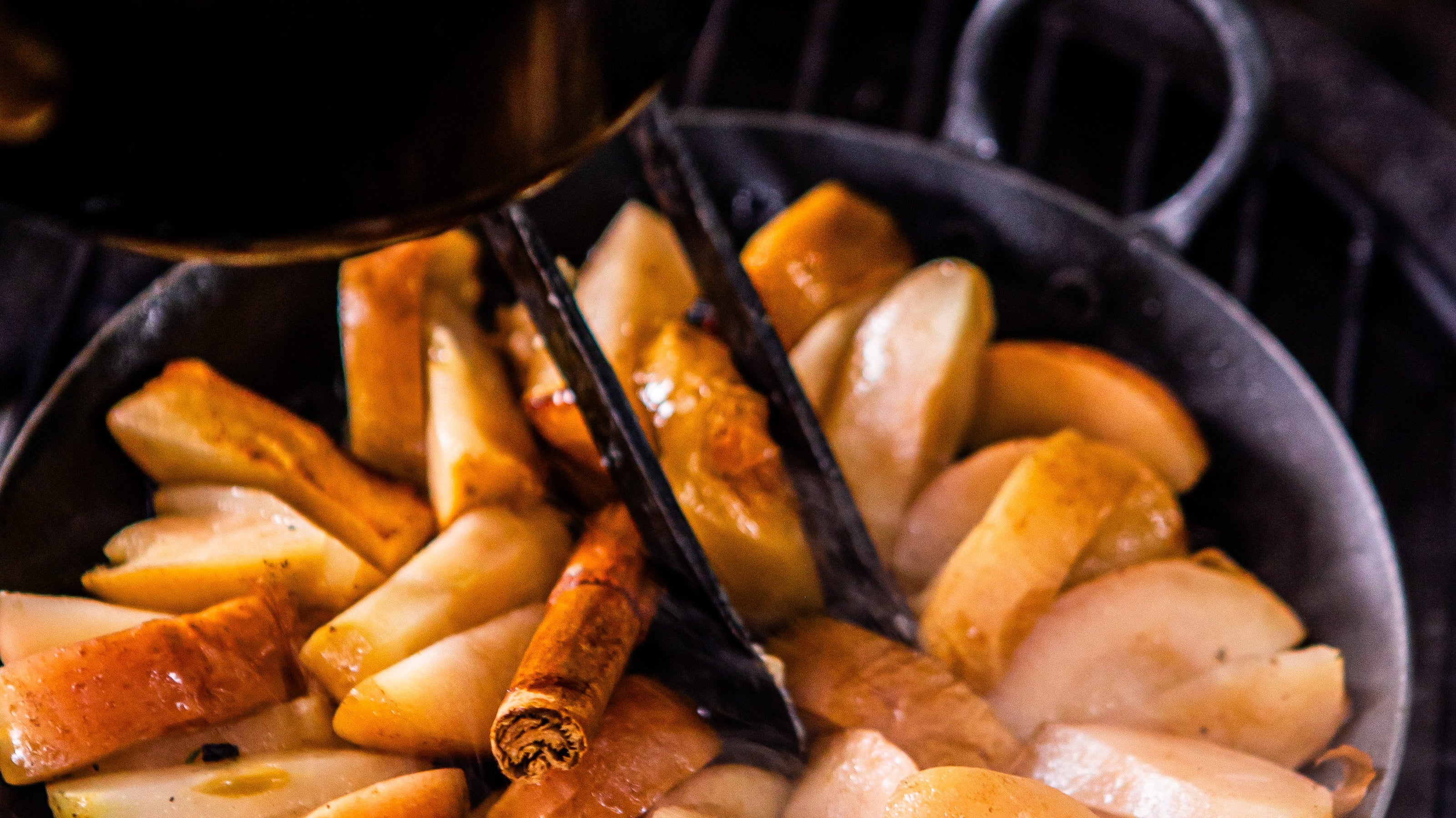 Apples cooking on a live fire Kadai BBQ with cinnamon