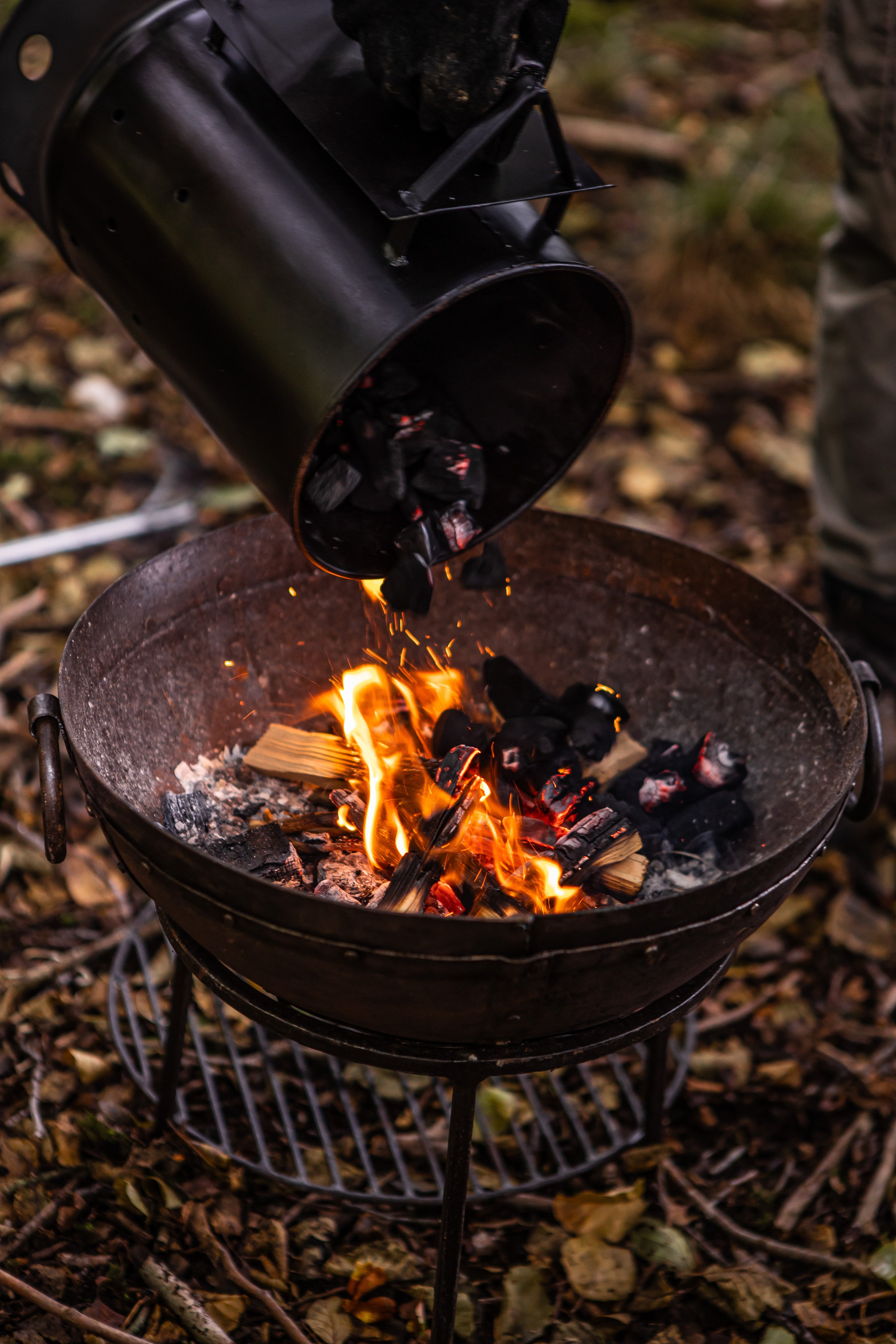 kadai charcoal starter pouring lit coals in travel firepit