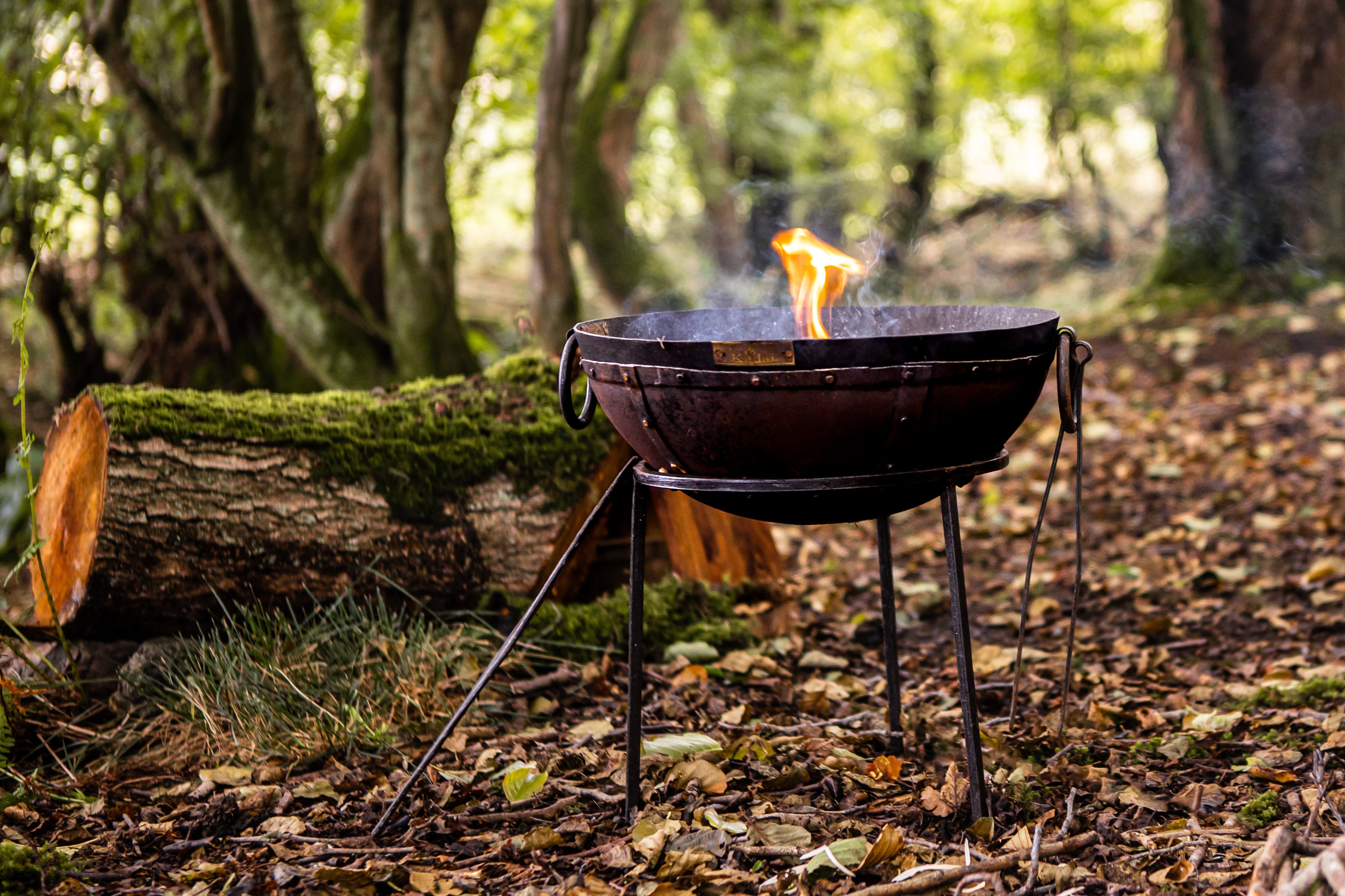 Kadai travel recycled fire pit in forest setting