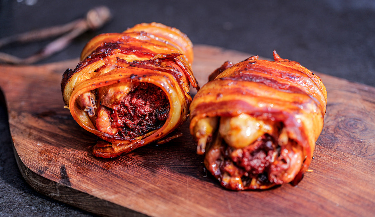 two small cooked partridges wrapped in bacon