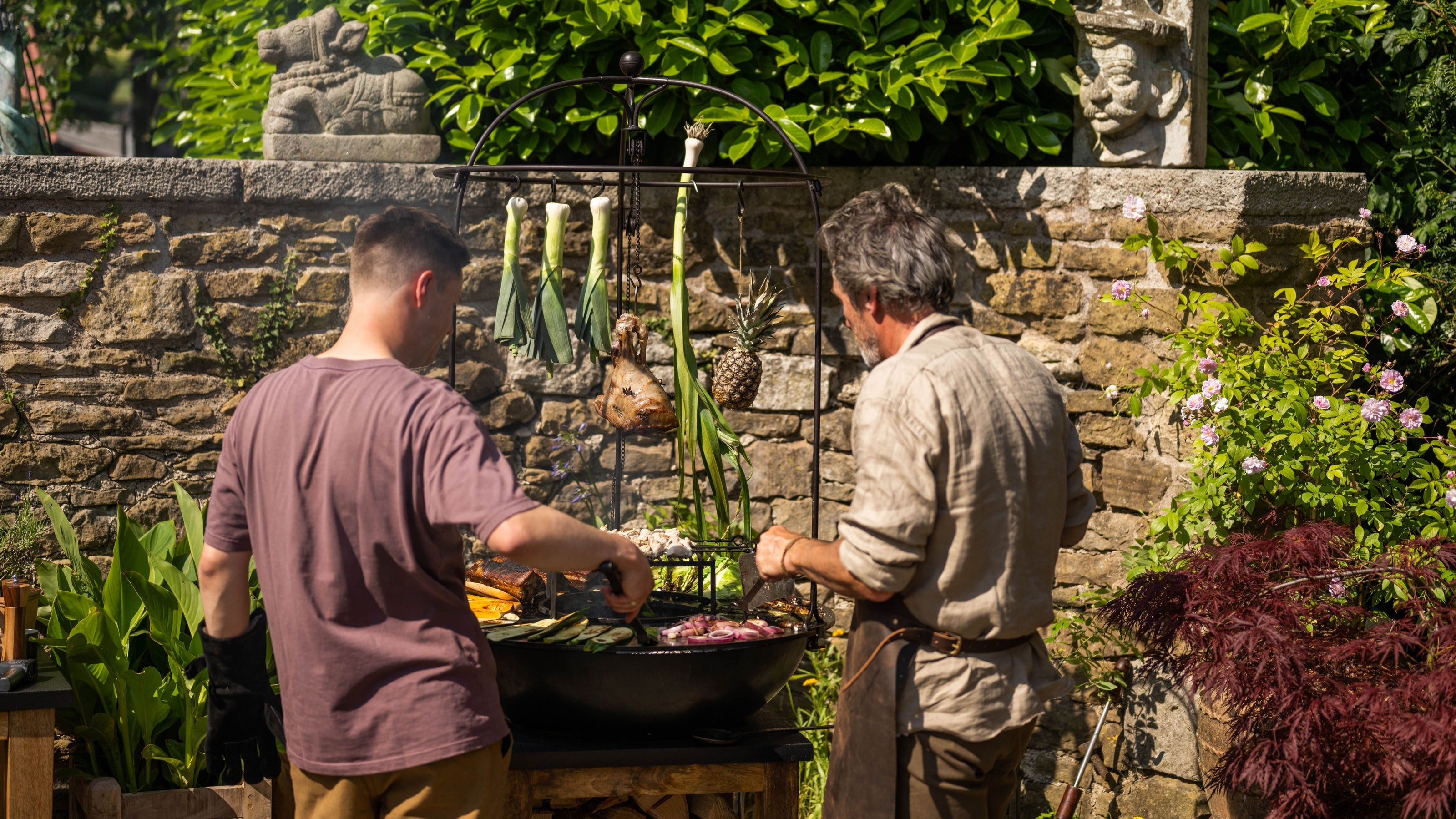 People grilling food on a barbecue plancha grill outdoors