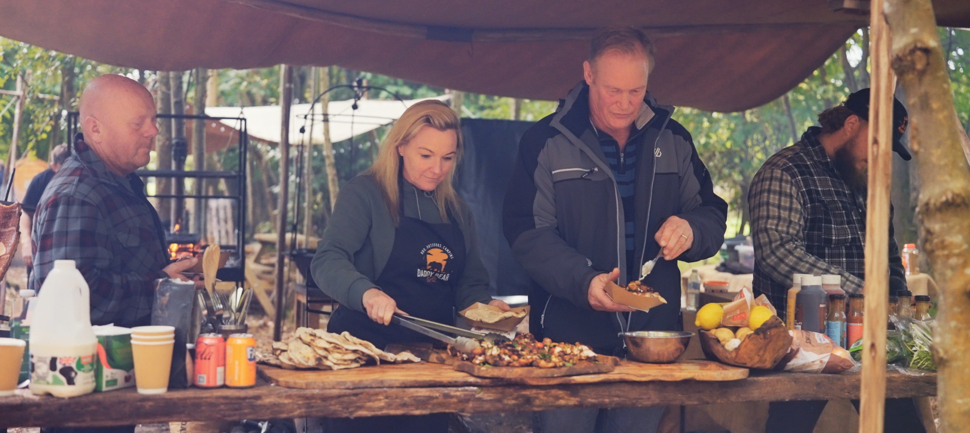 people eating food in outdoor setting