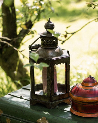 Decorative lanterns on a green surface with a blurred natural background