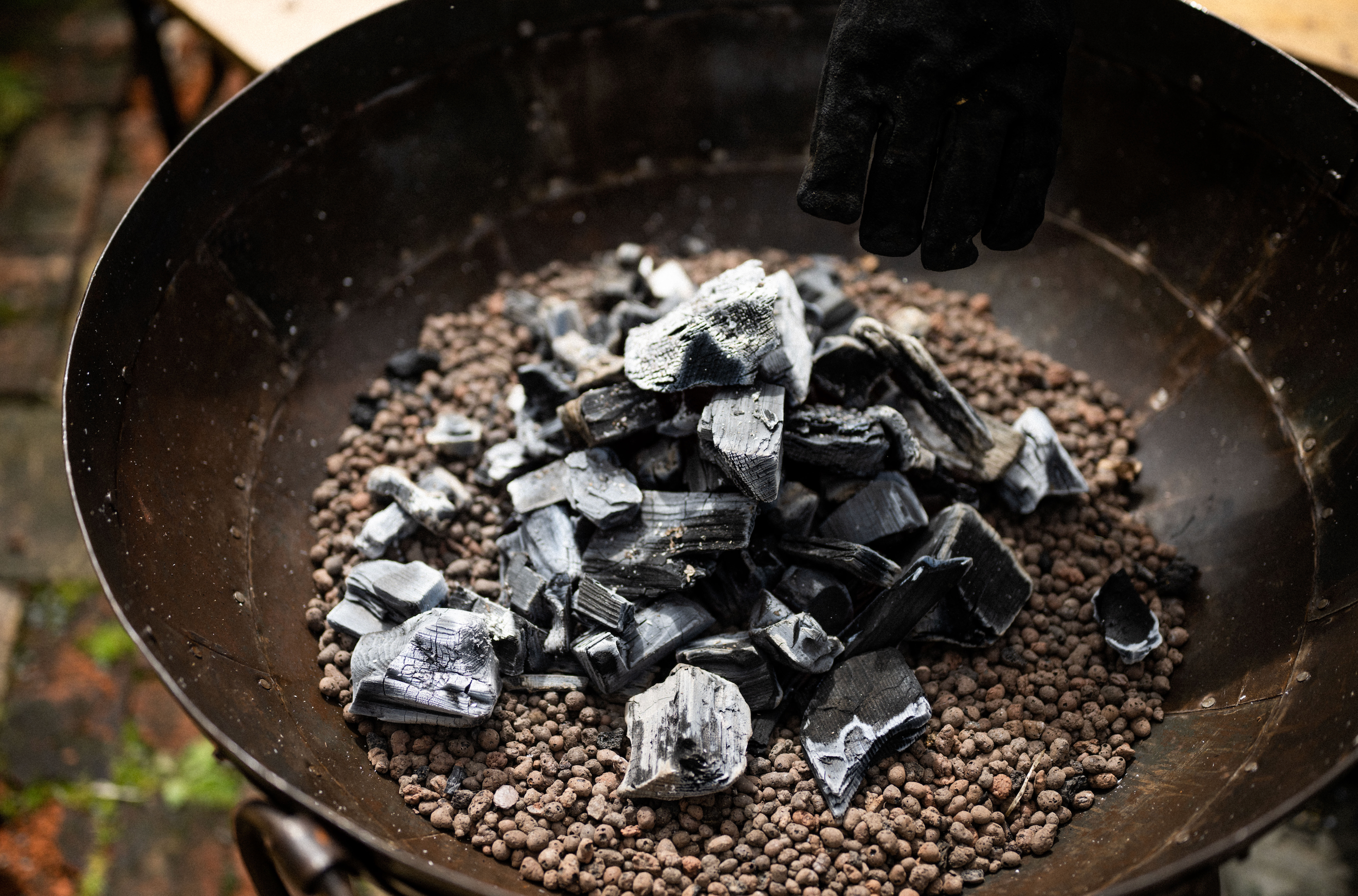 Hot white charcoal in the bottom of a Kadai BBQ Bowl.