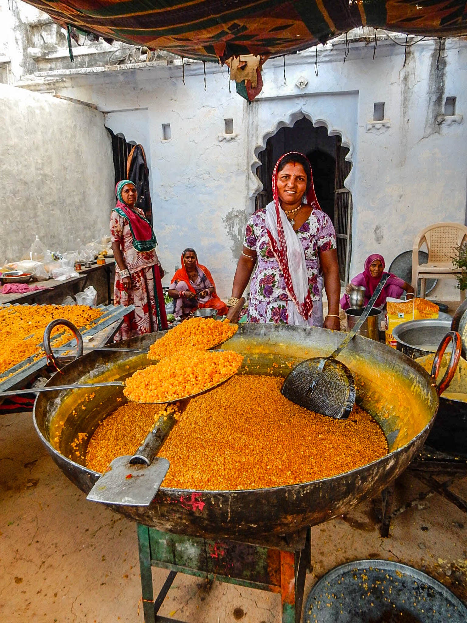 Indians using kadai firebowls to cook large quantity of rice