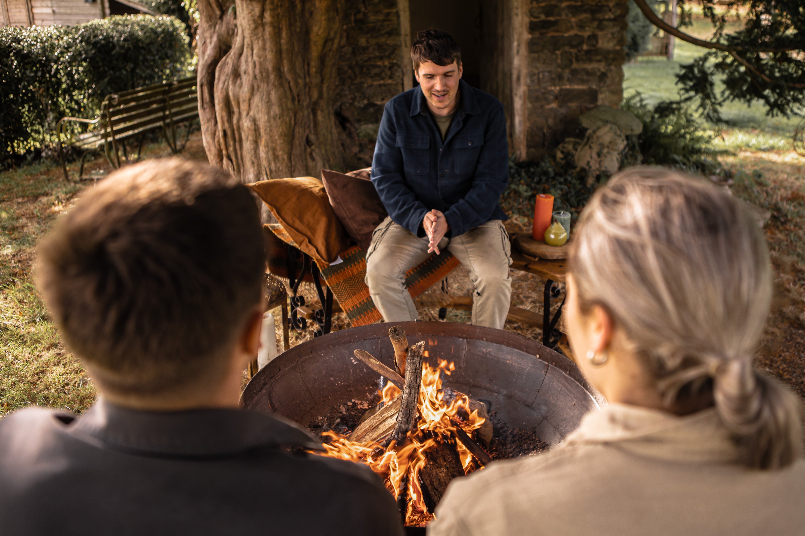 people sitting around Kadai Firebowl socialising in garden setting
