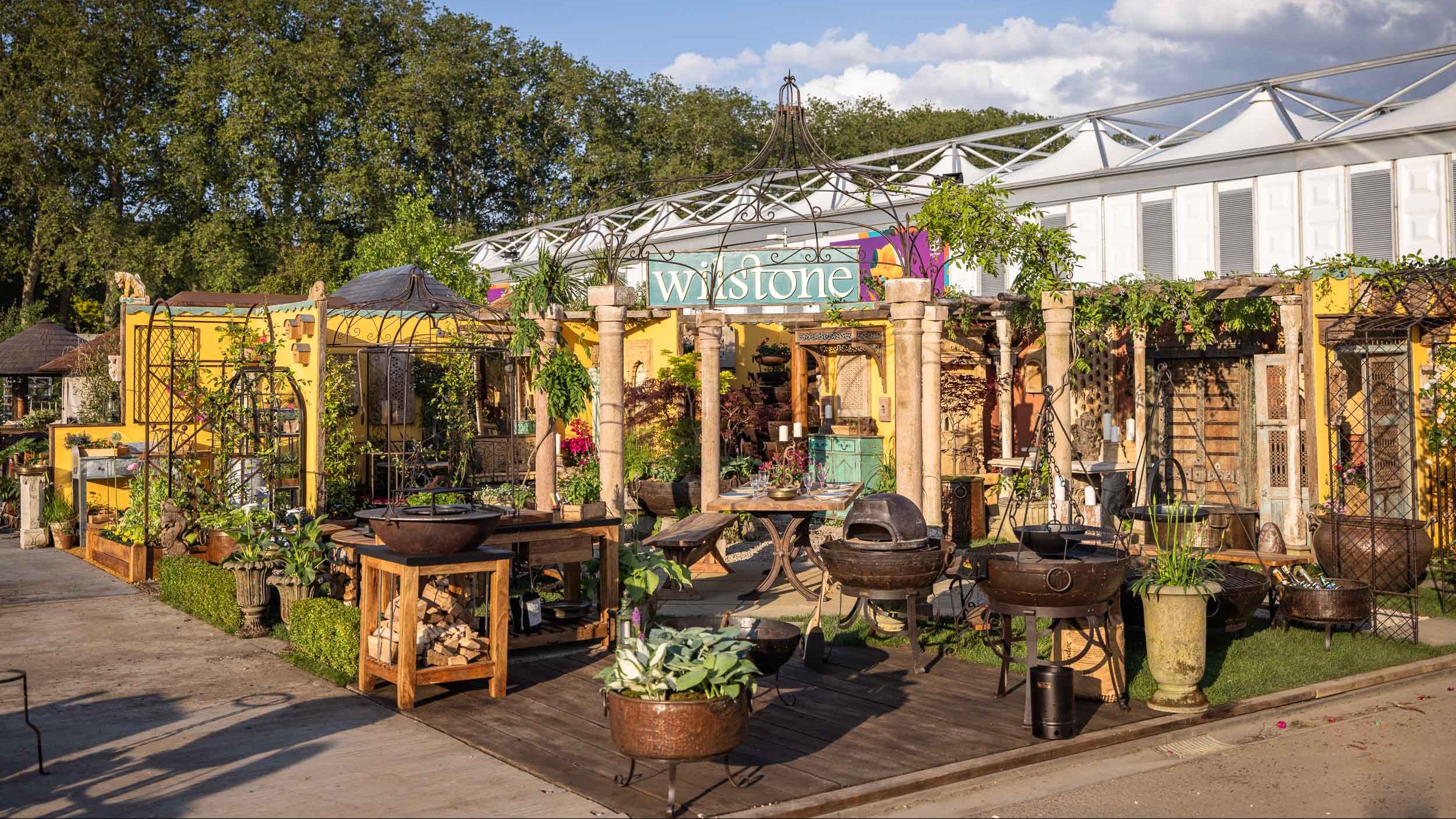 Outdoor stand at Chelsea Flower Show with a clear blue sky