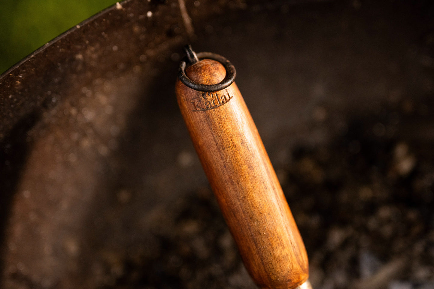 Close-up of a wooden-handled tool with a blurred background