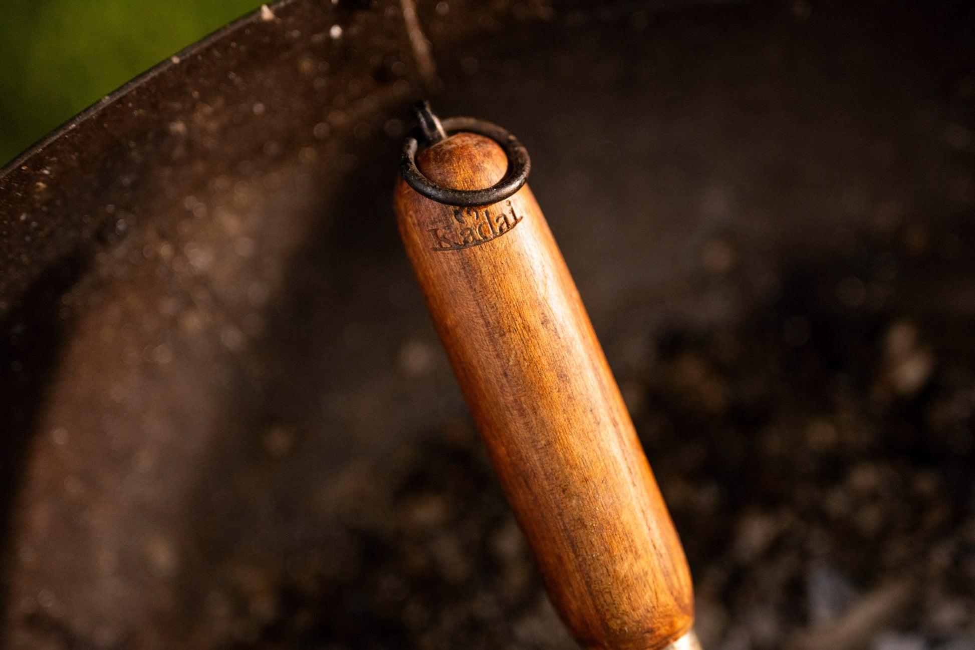 Close-up of a wooden-handled tool with a blurred background