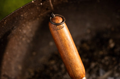 Close-up of a wooden-handled tool with a blurred background