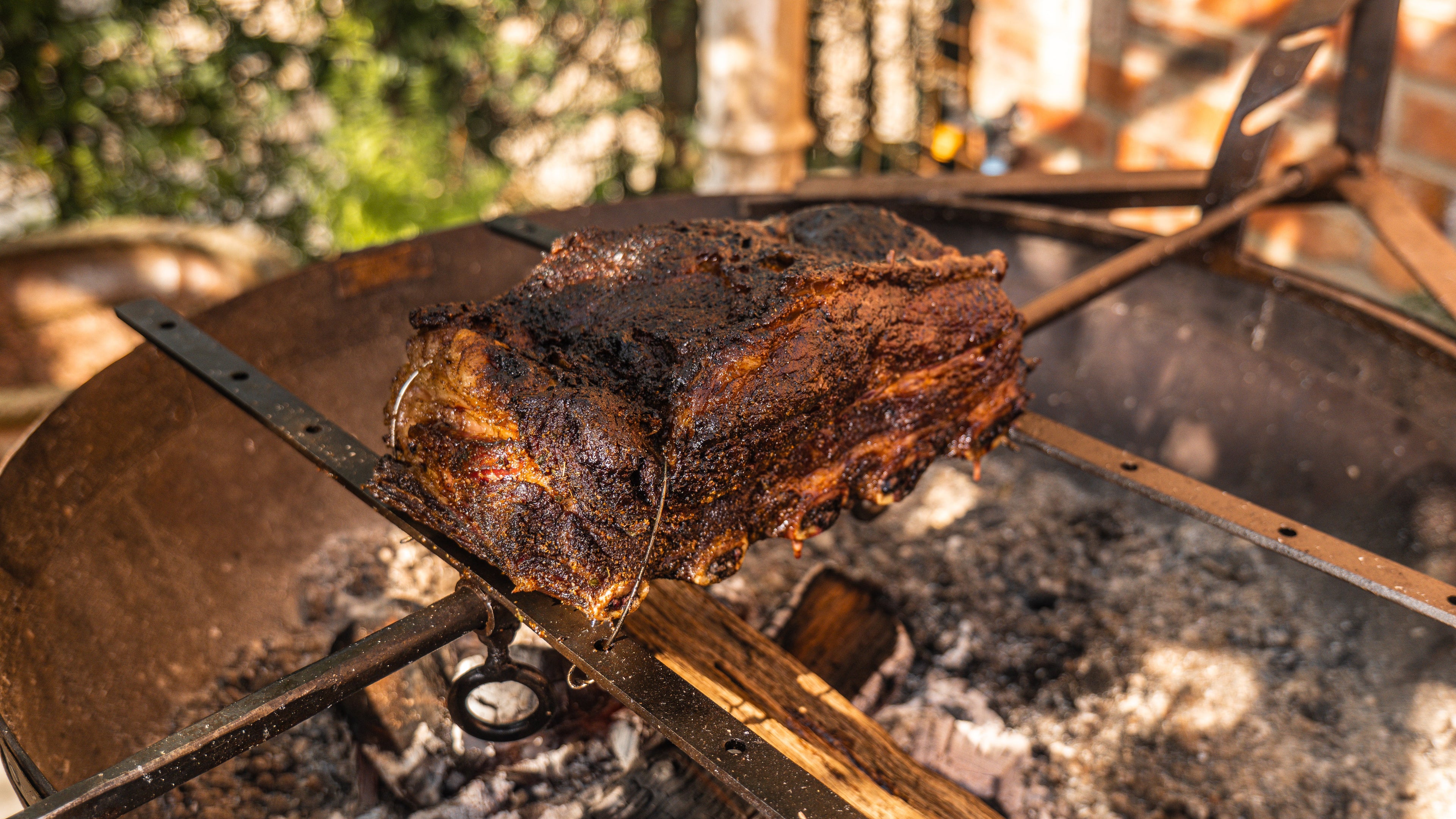 Beef short ribs slow cooked over fire using a Kadai Asado Cross.