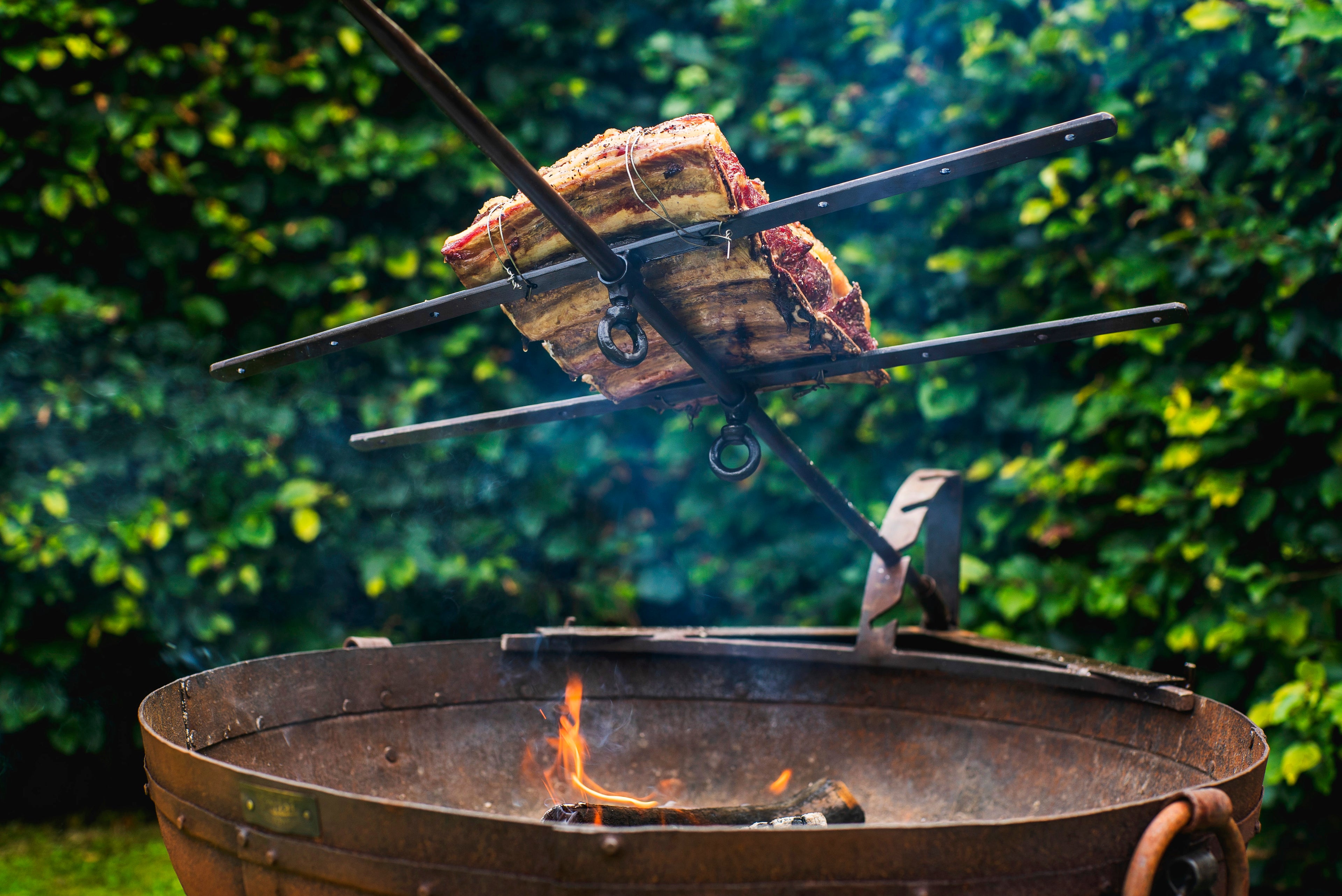 ribs cooking on asado cross
