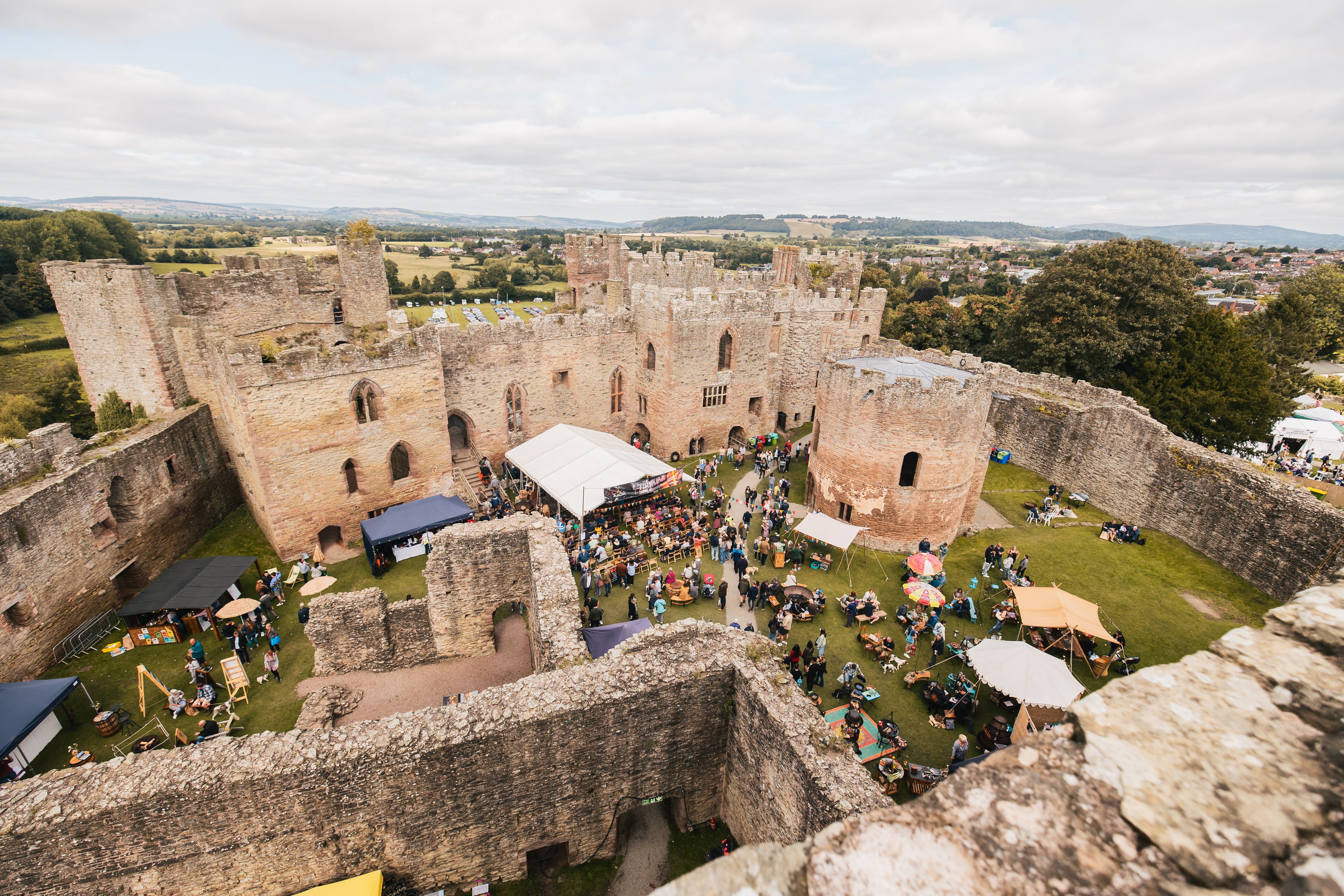 The Ludlow spring festival in a castle with people and tents.