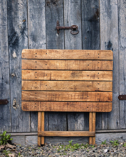 Compact handcrafted café table featuring natural wood grain and a classic folding design for outdoor spaces
