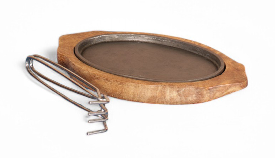 Metal Sizzler Plate with a wooden base on a white background