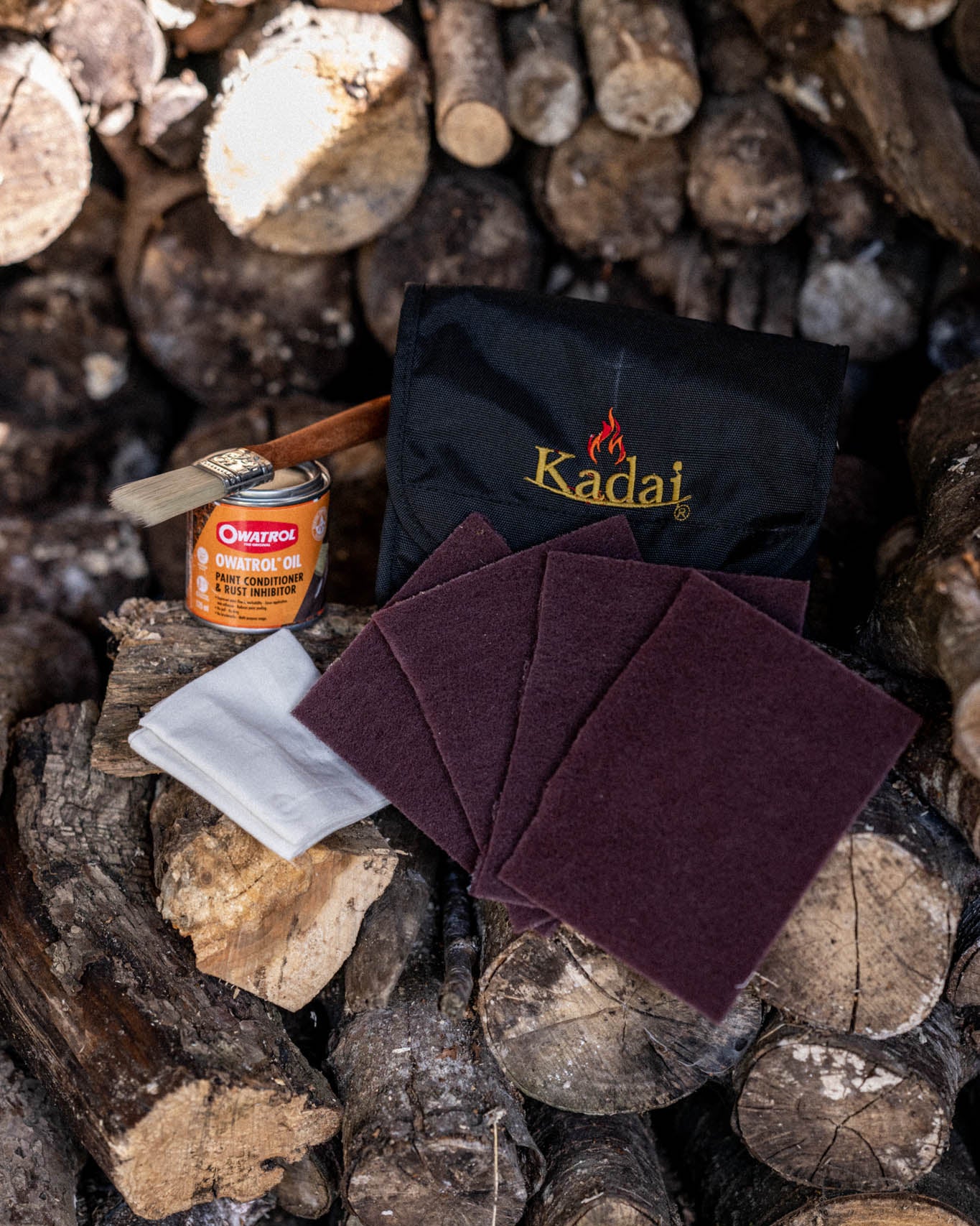 Outdoor fire pit maintenance kit featuring Kadai cleaning accessories and protective treatment supplies for metal cookware and fire bowls