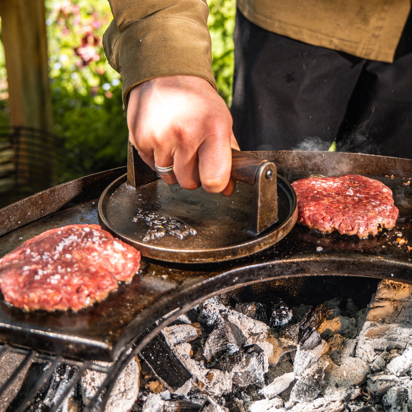 Smashed burgers on a bbq hot plate
