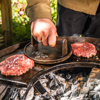 Smashed burgers on a bbq hot plate