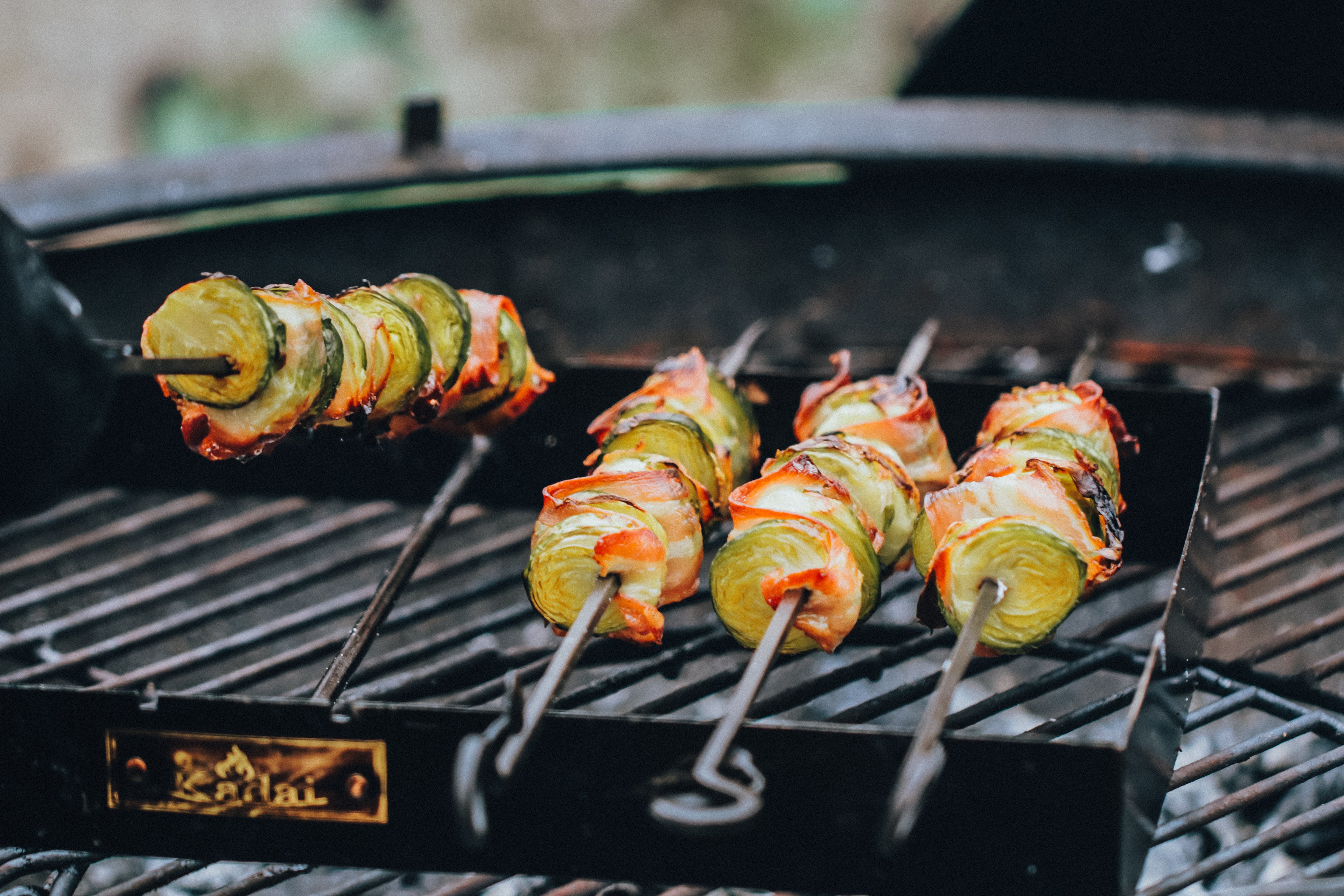 Vegetable skewers being grilled on a kadai barbecue