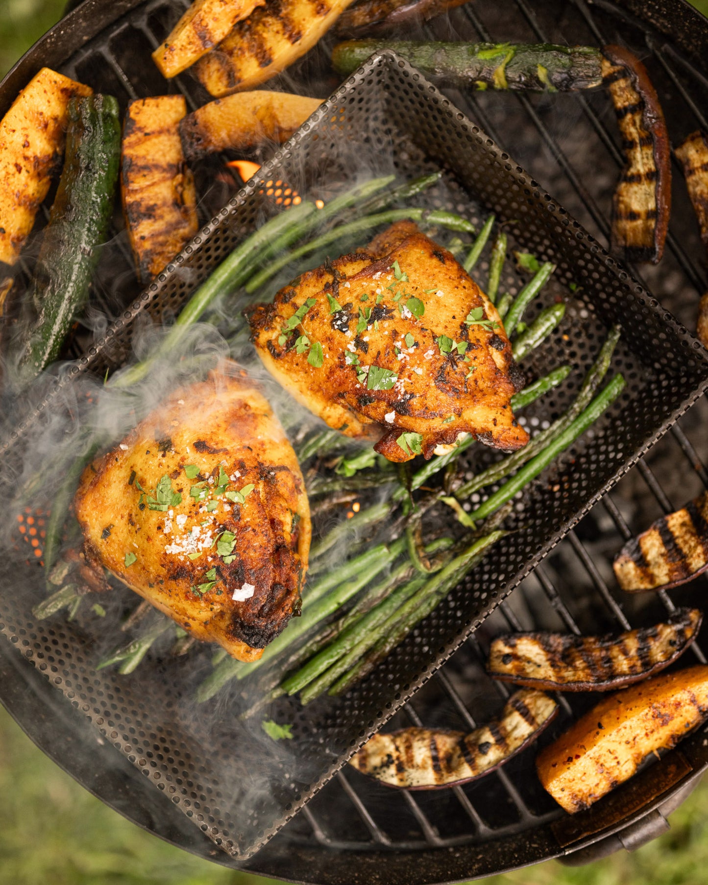 Cooking chicken and grilled vegetables on a portable bbq