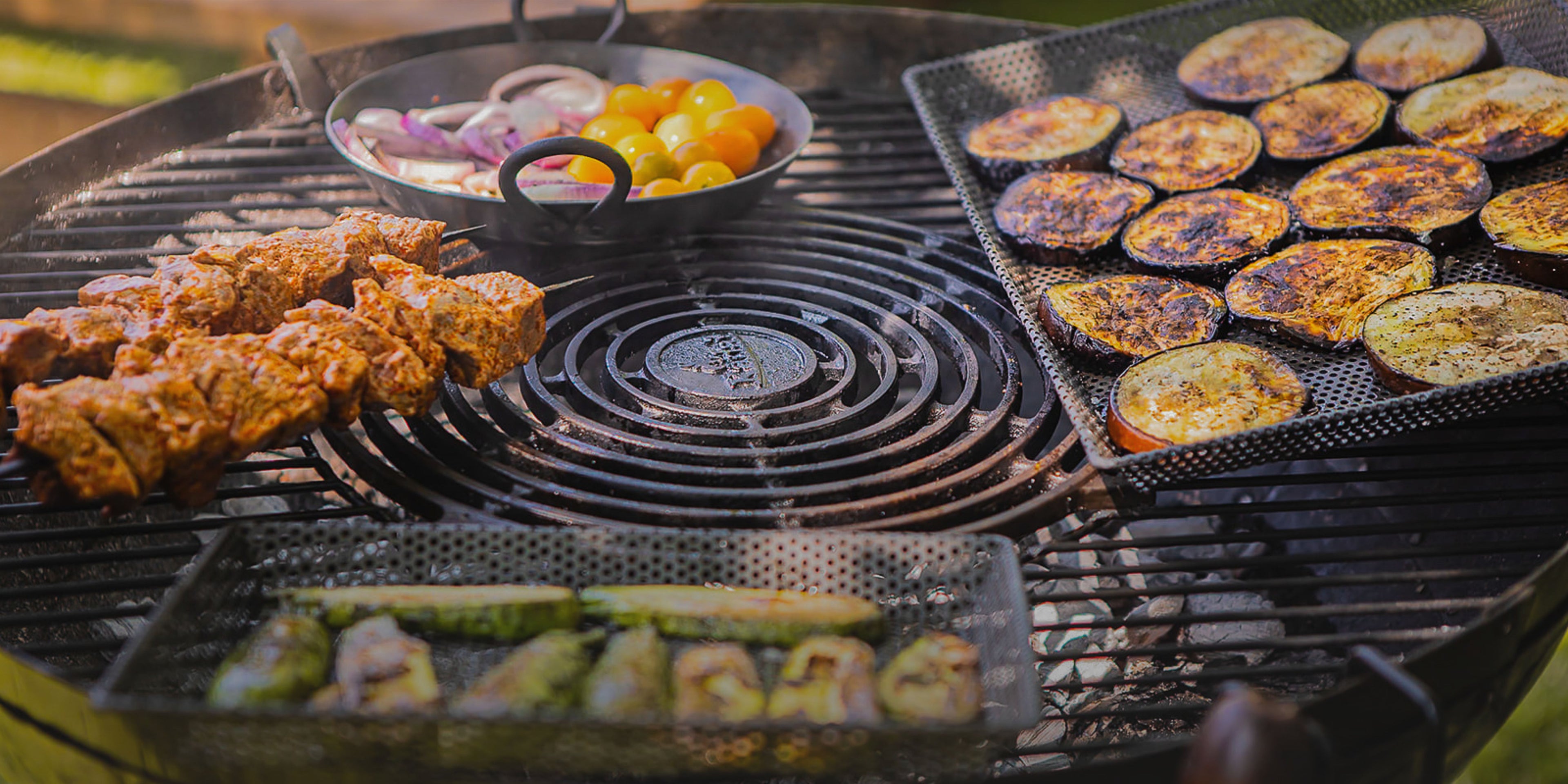 Kadai grill with barbecue accessories and vegetables.
