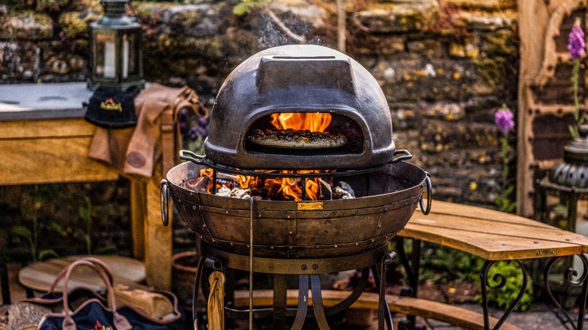 Outdoor setting with kadai pizza oven on recycled kadai in a patio garden setting