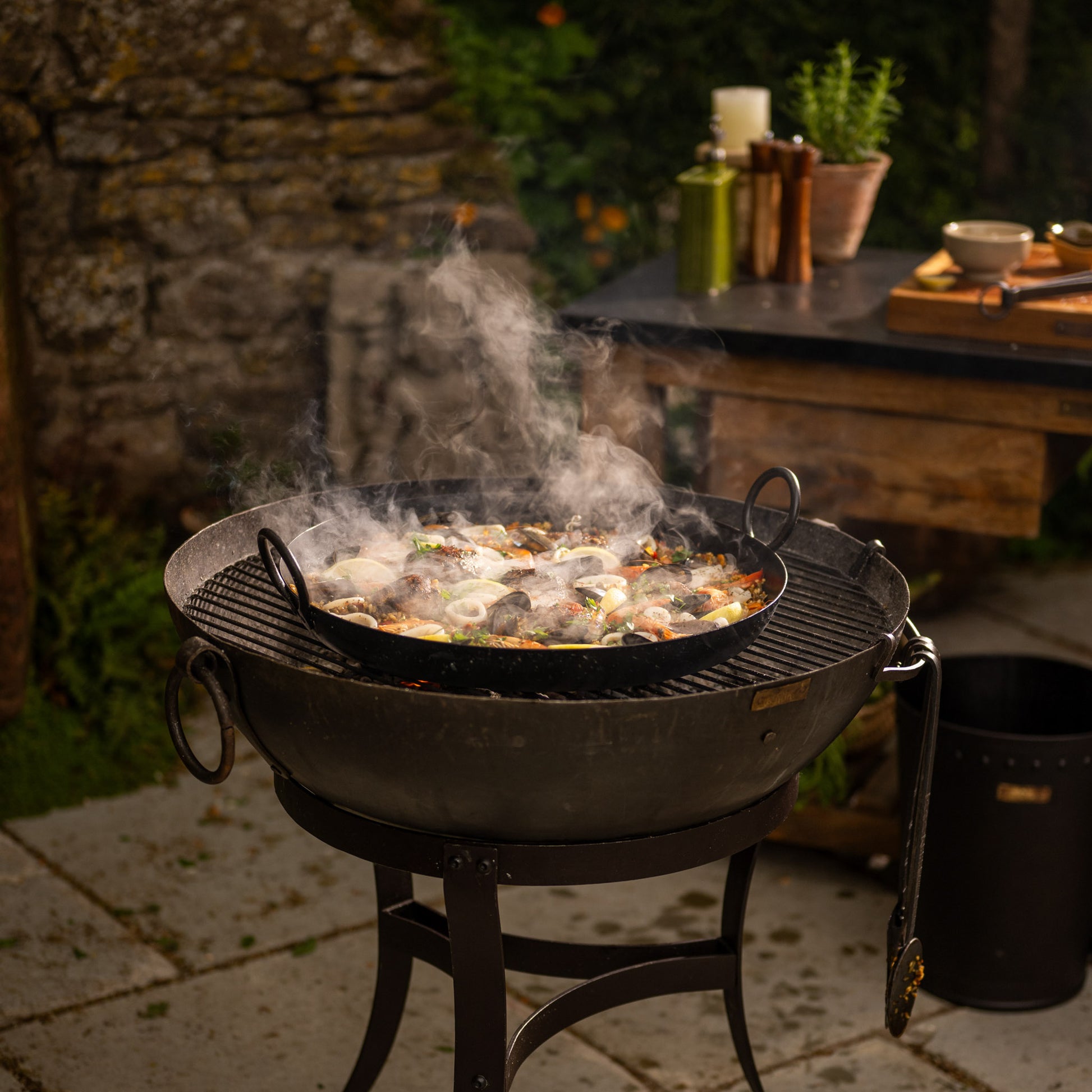 Paella pan on a bbq cooking a Paella