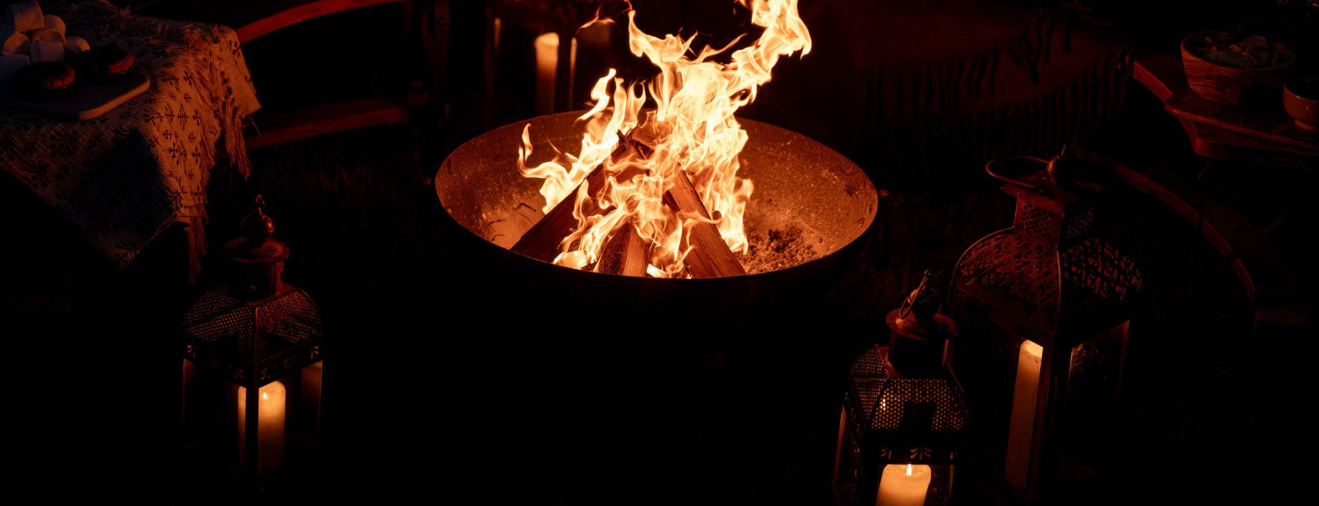 Handcrafted Kadai firebowl glowing into the evening, bringing warmth, atmosphere and live fire cooking to outdoor gatherings long after the sun goes down