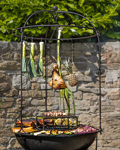 Outdoor grill with various vegetables on a stone wall background