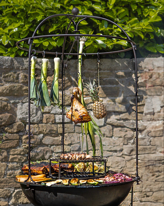 Outdoor grill with various vegetables on a stone wall background