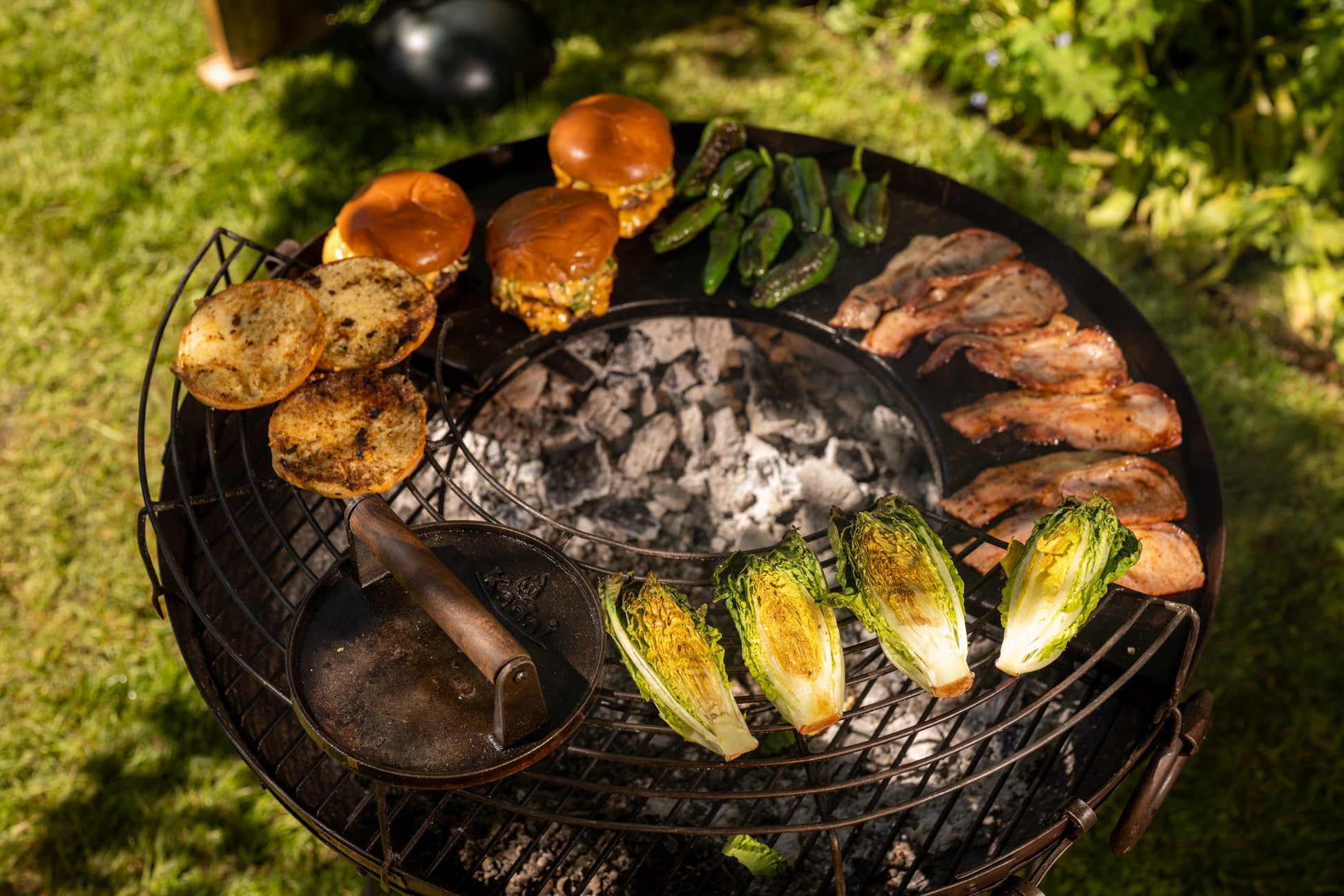 Grilled food on a barbecue grill with vegetables and meats