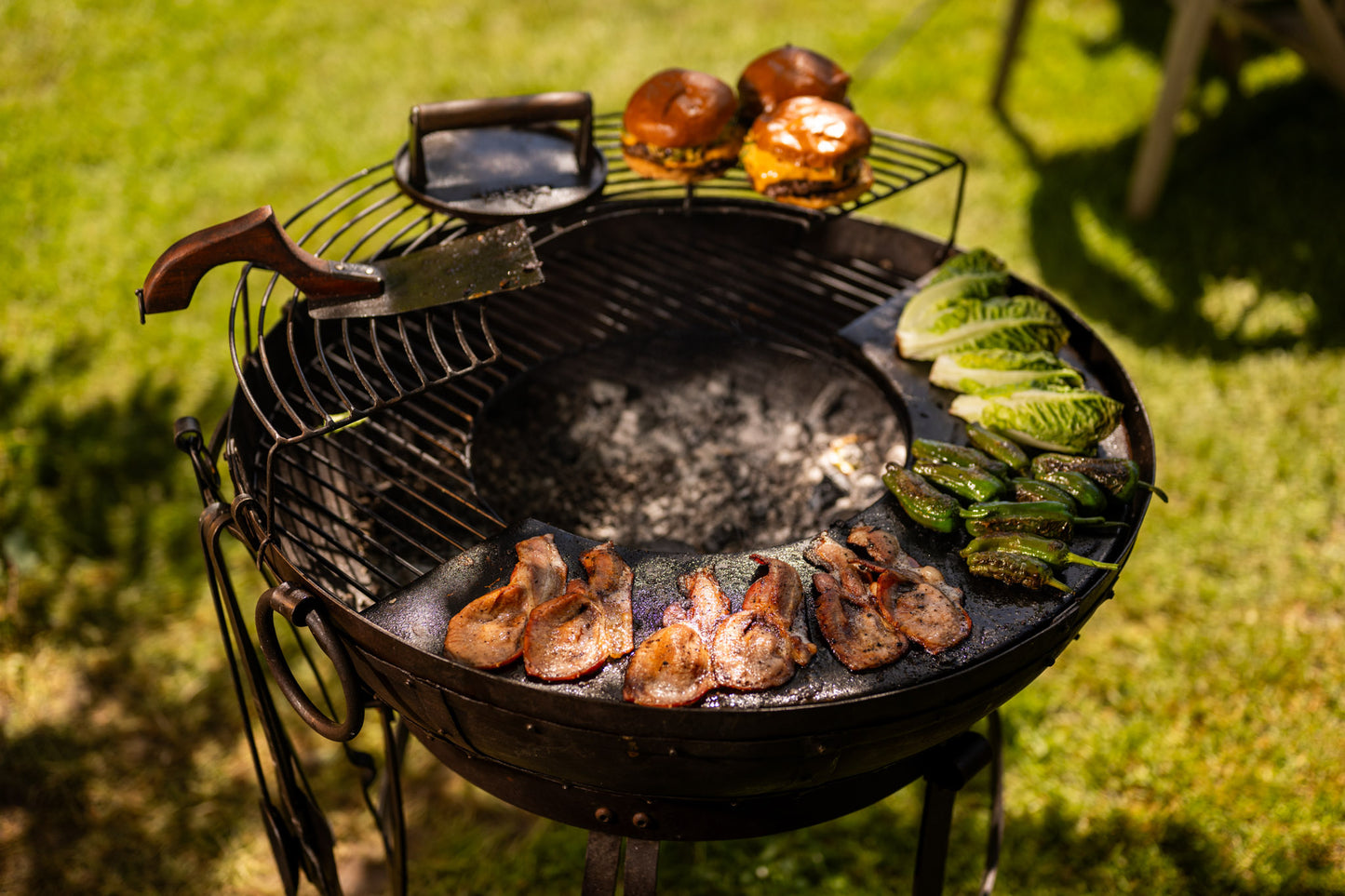Barbecue grill with food on a grassy background