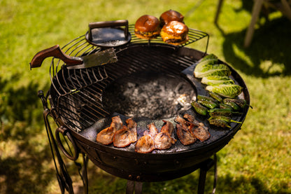 Barbecue grill with food on a grassy background