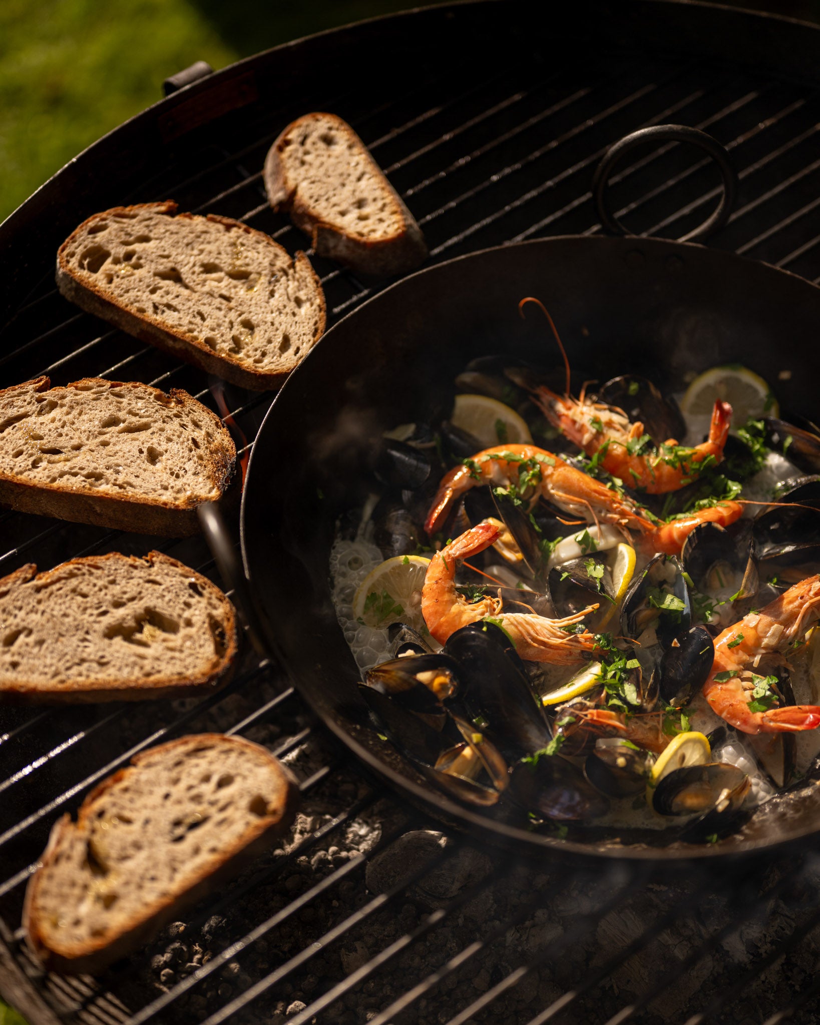 Grilled bread and seafood dish on a barbecue grill