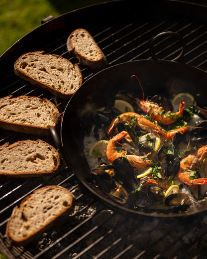 Grilled bread and seafood dish on a barbecue grill