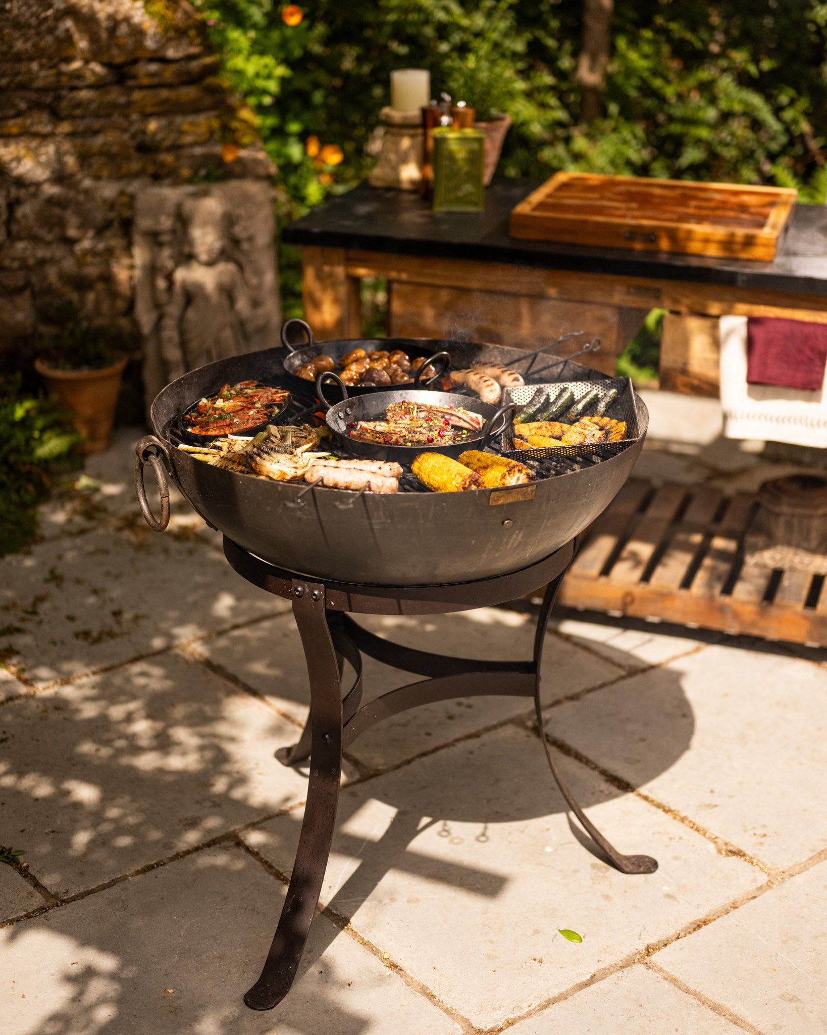 Outdoor BBQ grill with food on a patio.