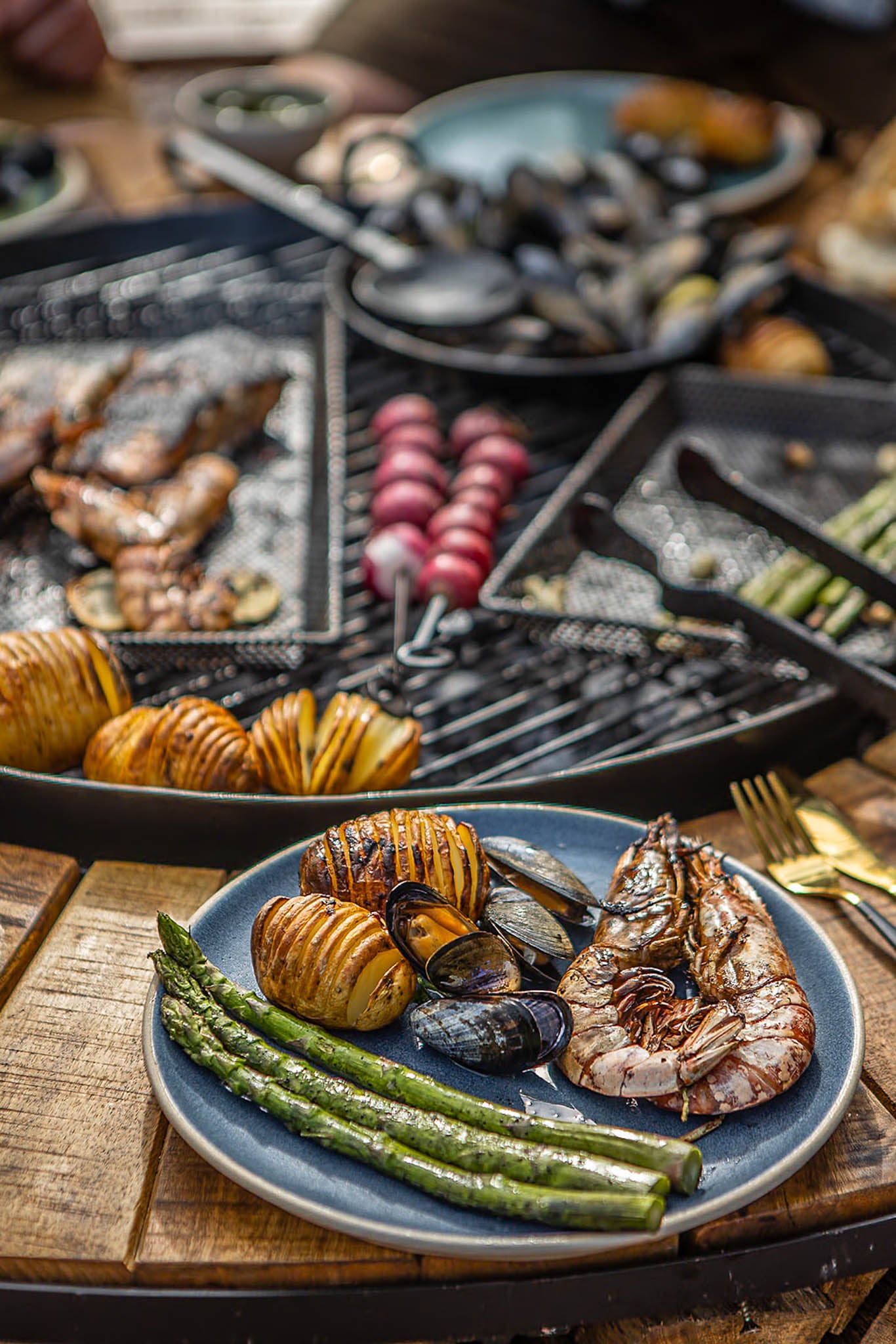 Assorted grilled seafood and vegetables on a wooden table