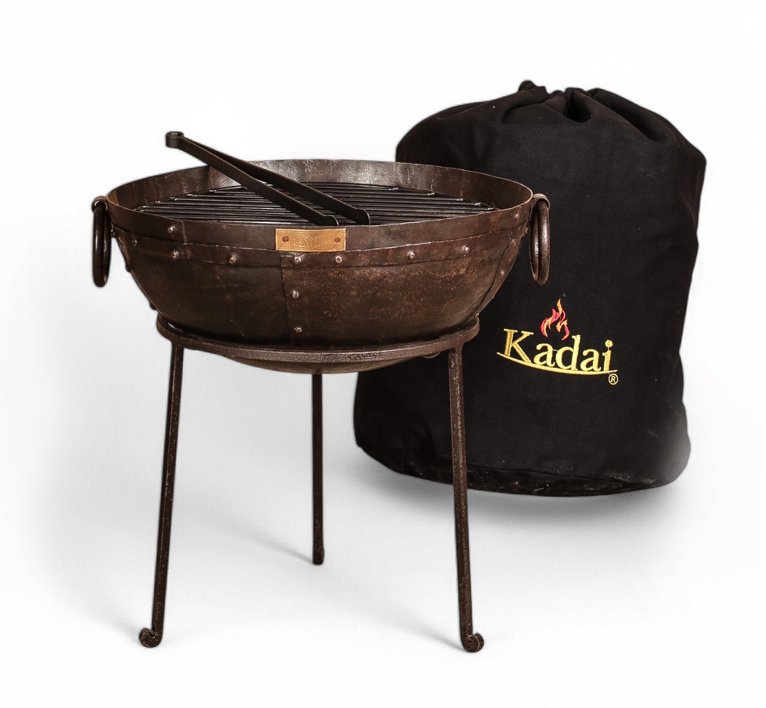 Brown metal fire pit with stand and black carrying bag on a white background, featuring the Kadai brand.