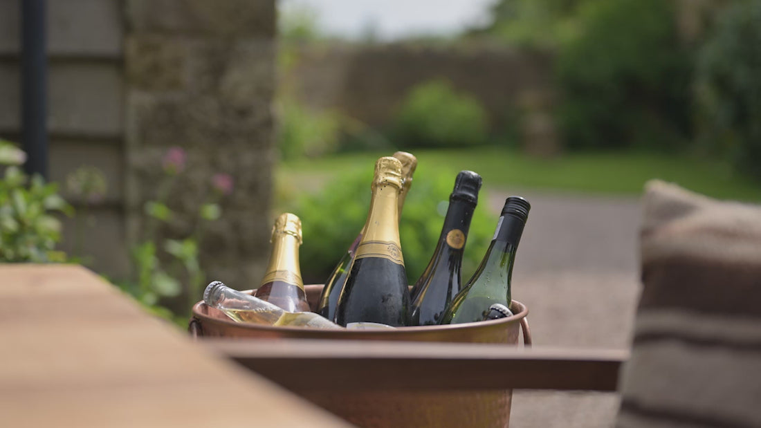 kadai club video of guy pulling wine out of cool box with ice and water